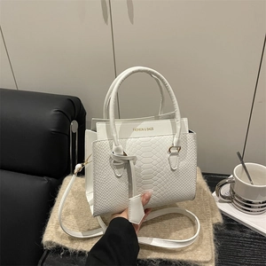 White snakeskin textured tote bag with golden hardware and fashion lettering design