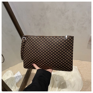 Brown geometric patterned tote bag with metallic zipper and wrist strap detail