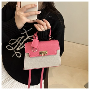 Detail of pink leather and woven canvas crossbody bag with gold-tone metal lock closure