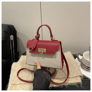 Close-up of stylish contrast color bag with red pebble leather and beige canvas textures