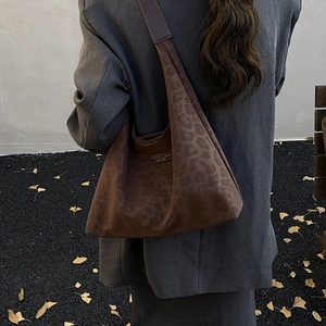 Large leopard print faux suede tote bag for women showing a stylish side view on shoulder