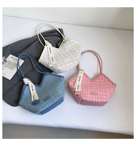 Detailed view of tweed bucket bags with leather trim and decorative ribbon bows