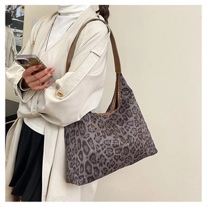 Detail view of large leopard print hobo shoulder bag with brown leather strap