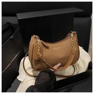 Brown woven hobo bag detail with gold chain and strap in luxury gift box set