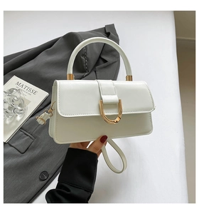 Close-up of matte white PU leather handbag featuring a stylish gold U-shaped metal buckle