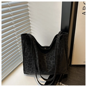 Detailed texture of large leopard print suede tote bag with double shoulder straps