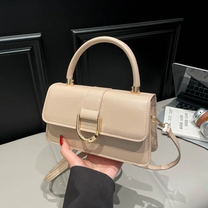 Beige faux leather handbag with golden D-shaped buckle and adjustable shoulder strap