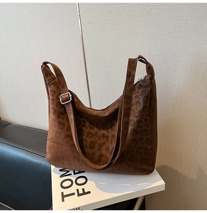 Detail of leopard print tote bag featuring silver adjustable buckle and sturdy strap