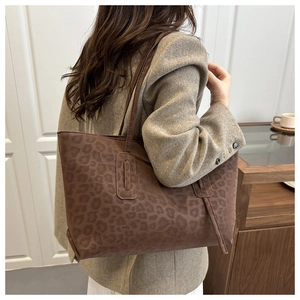 Detail of vintage leopard print tote bag with soft suede texture for daily commuting