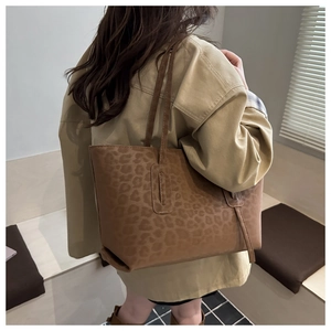 Brown leopard print tote bag styled with a khaki coat for a casual chic fashion look
