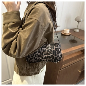 Close-up of leopard print shoulder bag with classic brown texture and slim strap
