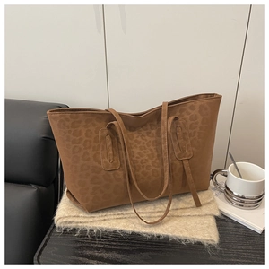 Detail of the leopard print pattern and soft suede texture on the brown tote bag