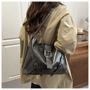 Detail view of large grey tote bag with vintage texture and metallic buckle details