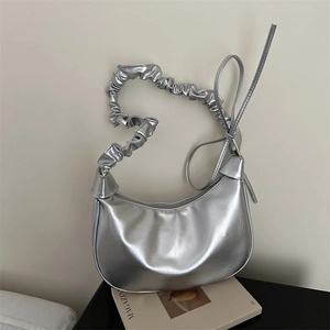 Silver metallic crescent bag with pleated cloud handle and sleek minimalist design