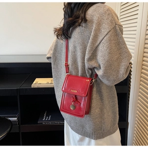 Detailed back view of a woman wearing the red leather fashion crossbody bag with strap