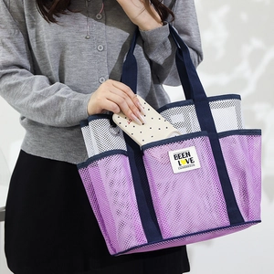 Large mesh beach bag in purple and white with blue handles and side phone pocket