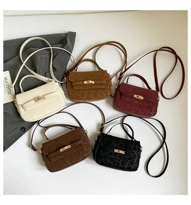 Detail of leopard print crossbody bags in various colors with metallic clasp closure