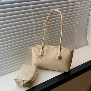 Creamy white 2-piece tote bag set with shoulder strap and small pouch in window light
