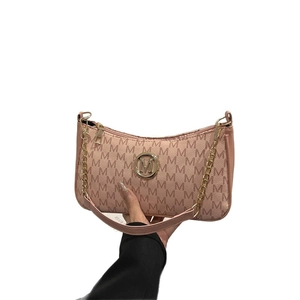 Sac croissant rose avec imprimé monogramme M et bandoulière en chaîne dorée sur fond blanc