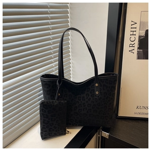 Detail view of leopard print tote bag set with matching small zipper pouch and gold hardware