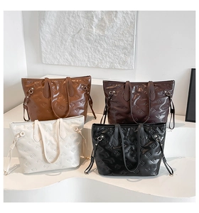 Detailed close-up showing four color variants and bow-embossed texture on tote bags