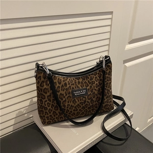 Large leopard print tote bag with black leather trim and crescent shape for women