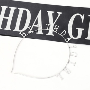 Close-up of silver metal headband and black silk sash with Birthday Girl lettering