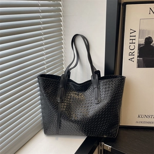 Minimalist black woven faux leather tote bag with long handles for stylish daily commute