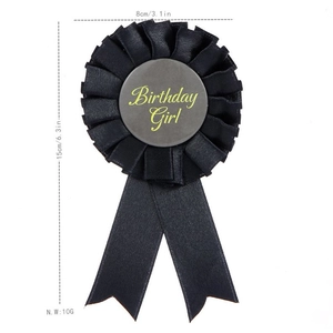 Detail of black ribbon Birthday Girl badge with dimensions 8cm by 15cm for party decor