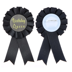 Detailed view of Birthday Queen award rosette badge with satin ribbons and pin back