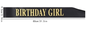 Detail of black satin Birthday Girl sash with gold lettering and size dimensions