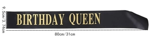 Detail of black satin birthday queen sash with shiny gold lettering and size dimensions