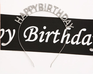 Dettaglio del cerchietto Happy Birthday in strass argento con una fascia da festa in raso nero