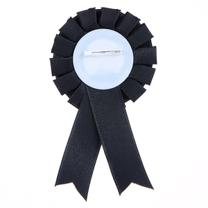 Back detail of black satin birthday girl award ribbon badge with secure safety pin