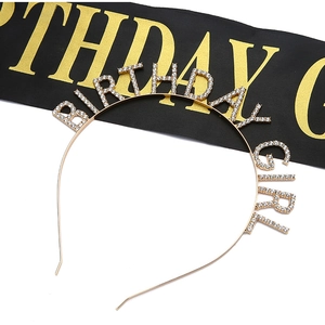 Detail of gold metal Birthday Girl headband with white rhinestones and a black satin sash