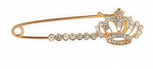 Macro detail of a golden crown safety pin brooch featuring pavé set sparkling rhinestones