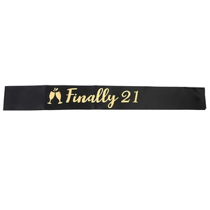 Black satin 'Finally 21' birthday sash with gold lettering and champagne glass icons