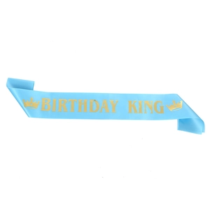 Close-up of sky blue satin sash with gold foil Birthday King text and crown logo