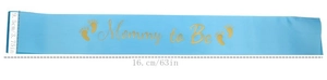 Detail showing blue satin Mommy to Be sash with gold lettering and footprint pattern
