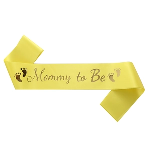 Yellow satin Mommy to Be sash with gold foil lettering and footprints for baby showers