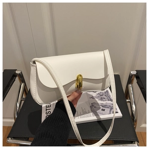 Close-up of minimalist white leather shoulder bag featuring a gold oval metal lock