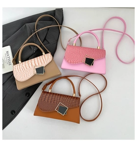 Three minimalist crossbody bags in beige, pink, and coffee with crocodile texture detail