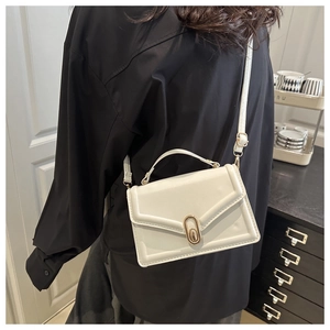 White minimalist square crossbody bag with gold oval metal clasp and top handle