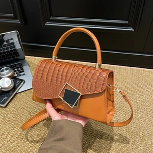 Orange crossbody bag with crocodile embossed flap and square gold metallic buckle