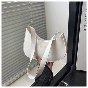 Detail of white crescent shoulder bag with golden FASHION & BAGS lettering
