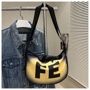 Detail of hobo crossbody bag with yellow to black gradient and bold FE lettering print