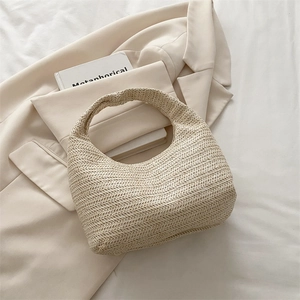 Sac hobo chic en maille crème pour les vacances à la plage sur fond de blazer beige élégant
