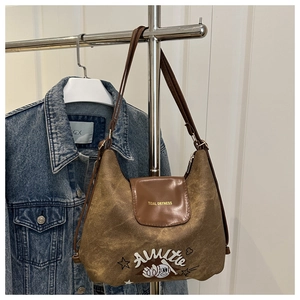 Detail view of vintage brown tote bag featuring retro Almitte and baseball embroidery