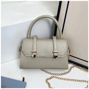 Detail of champagne gold crossbody bag with Saffiano texture and metal belt trim