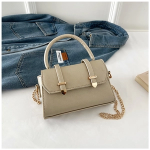 Detail of khaki crossbody bag featuring cross-grain texture and golden belt accents